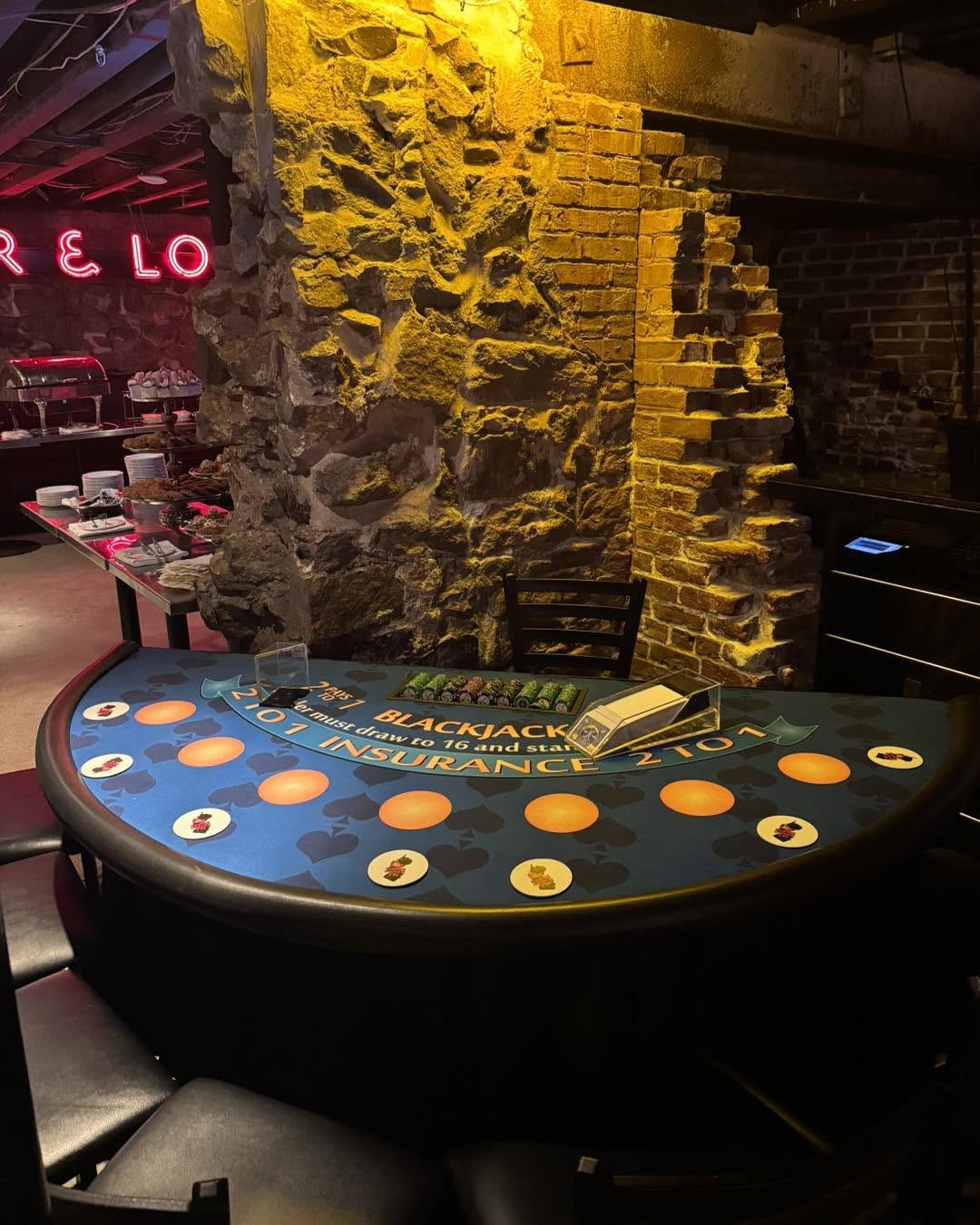 Blackjack table set up beside exposed stone and brick walls